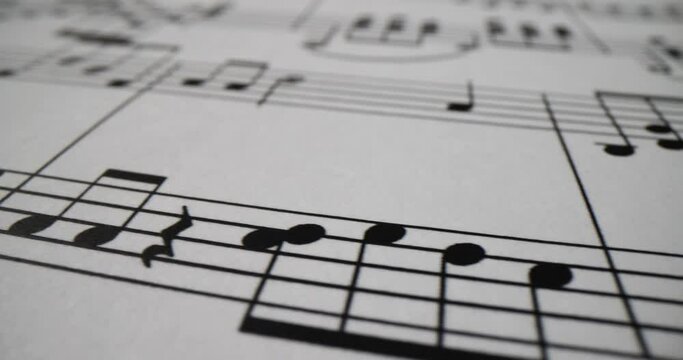 Musical notes printed on sheet of paper closeup. Musical literacy