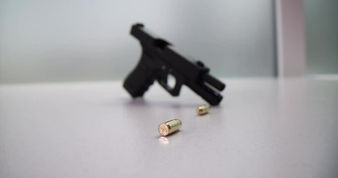 Pistol golden bullets and black pistol. Weapon permit concept