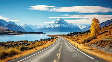 Wall murals Aoraki/Mount Cook a course of a road with a lake and mountains in the background.