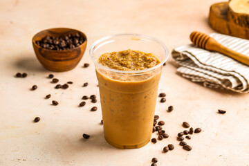 Iced Latte with coffee beans served in cup isolated on wooden board top view cafe drink