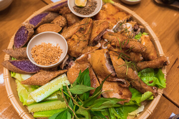 Barbecue chicken serving on bamboo basket in Da Lat, Vietnam.
