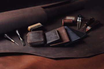 Top view tailor products make from skin. Case, purse made of natural leather brown color with tools
