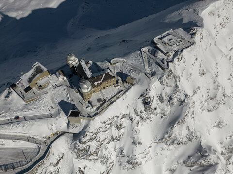 Snowy ski resort on mountains in sunlight - Powered by Adobe