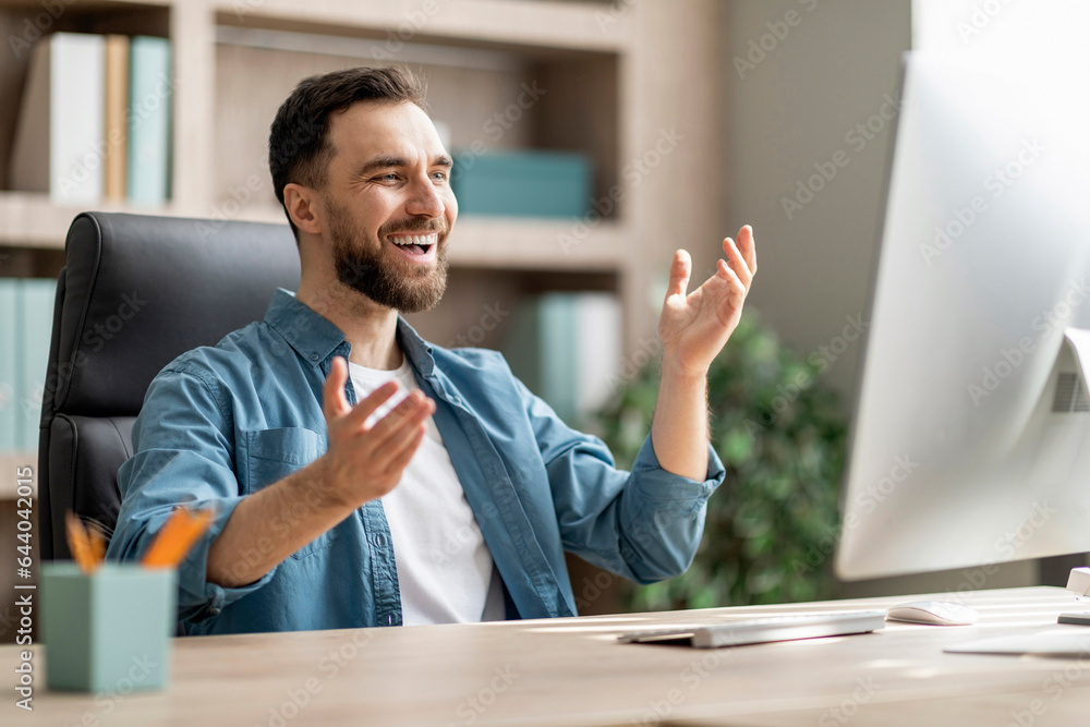 Aufkleber happy businessman making teleconference on computer while sitting at desk in office