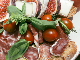 close-up cutting of smoked meat, prosciutto, sausages, cheese for a delicious meal.