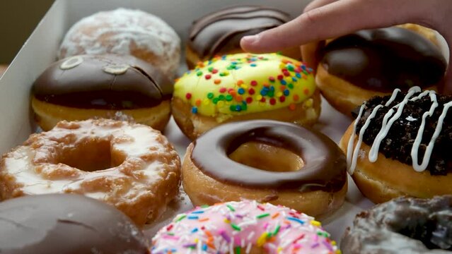assorted donuts with different fillings and icing. Dolly video. High quality FullHD footage