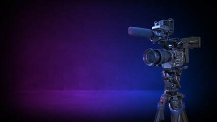 Professional digital film camera recording video in studio with pink and blue lighting. Television...