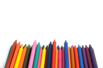 Crayons lined up isolated on white background.