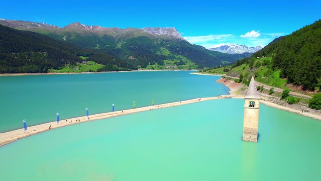 Lake Reschen - Vinschgau South Tyrol - fantastic flight aerial view of the church tower in the reservoir
