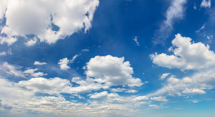 Panoramic sky - real blue sky during daytime with white light clouds Freedom and peace. Large photo format Cloudscape blue sky.