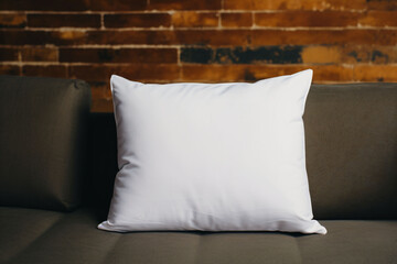 Blank white pillow on a modern sofa, pillow mockup
