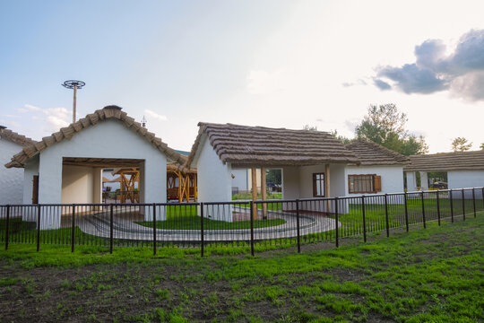 Belgorod, Russia - August 23, 2023: New Belgorod amusement attractions park Kaleidoscope with houses a thatched roof in a South Slavic rural style. Magic Express Zone.