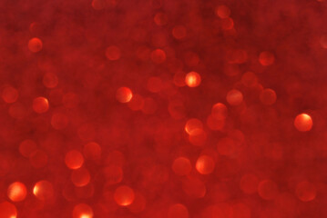 Red de focused sparkle glitter background with golden particles close up
