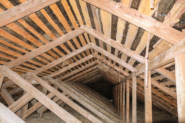 Wooden roof structures. Interior of cold unheated loft.