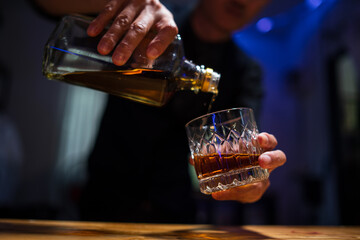 Barman pouring whiskey whiskey glass beautiful night