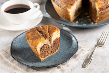 Marble cake and cup of coffee on the table.