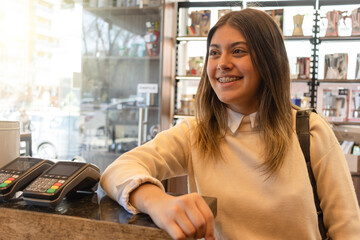 Young woman waiting to be served in coffee shop.