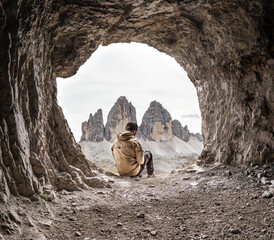 Hiker in front of the Three Peaks of Lavaredo, (Tre Cime di Lavaredo) in Dolomites, Italy - obrazy, fototapety, plakaty