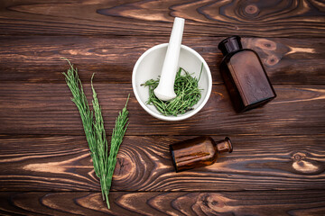 cup of tea from horsetail, made from fresh potion, from pharmacy mortar. Horsetail infusions are used as a diuretic for edema, 