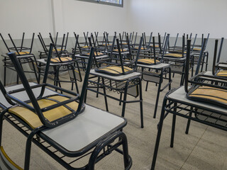 Empty tables and chairs in a school. Teacher strike concept.