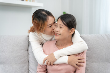 Mother day, cute asian teen girl hugging and kissing on the cheek, mature middle age mum. Love, kiss, care, happy smile enjoy family time. celebrate special occasion, happy birthday, merry Christmas.