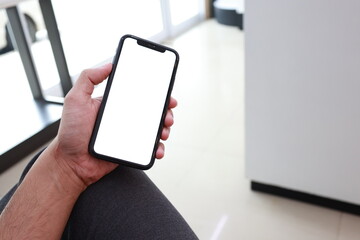 hand holding smartphone with blank screen