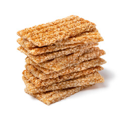 Pile of sesame snaps isolated on white background close up