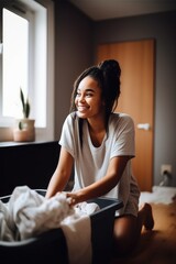 shot of a young woman folding laundry at home