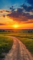A dirt road with a sunset in the background