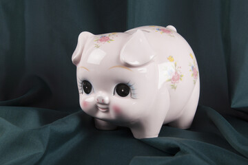 a vintage piggy bank in pink with flower designs