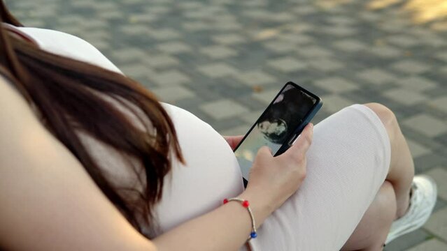 In a bustling public place, a pregnant young woman