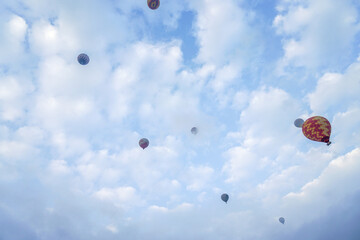 Blue sky filled with balloons
