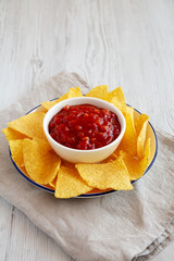Homemade Salsa and Tortilla Chips on a Plate, side view.