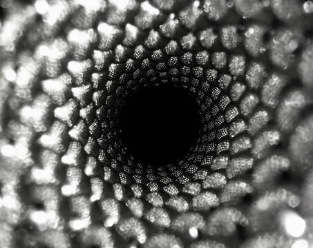 an endless spiral of balls. recursion ends with a black hole. black and white