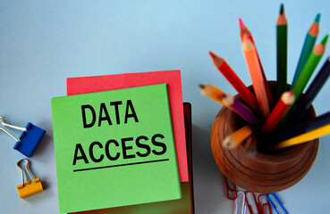 DATA ACCESS - words on a green sheet for notes on the background of pencils and paper clips