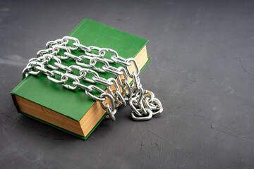 there are many turns of a metal chain on the book, a book that is prohibited