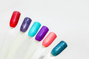 Palette of nail designs, testers of multicolored polishes on flat nails