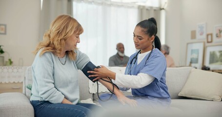 Nurse, appointment and blood pressure with senior woman at nursing home for wellness. Caregiver,...