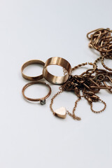 Blackened from the water, damaged poor-quality jewelry on a white background