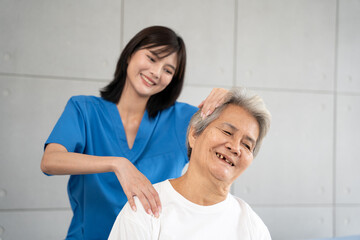 Fototapeta premium Senior woman being massage by nurse at hospital. She feeling happy and relax with massaging in clinic.