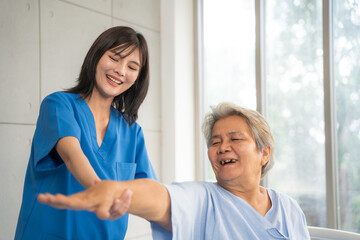 Fototapeta premium Beautiful asian nurse taking care of senior woman to exercise at hospital. She feeling happy when take care senior woman. Healthcare, Retirement, Volunteer, Caregiver and Lifestyle concept.
