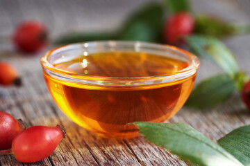 Red rosehip seed oil in a glass bowl