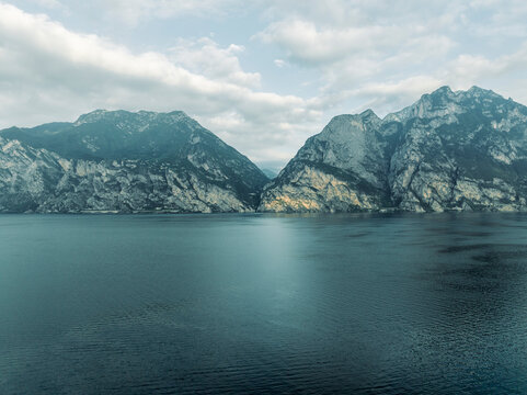 Aerial view of the Garda Lake at sunrise with high mountains near Torbole, Trentino, Italy.