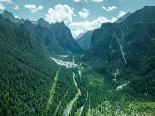Aerial view of a road across the valley at Tre Cime Natural Park on the Dolomites mountain range, Toblach, Trentino, South Tyrol, Italy.