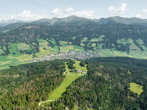 Aerial view of San Candido town as seen from Croda dei Baranci (Birkenkofel) mountain peak on the Dolomites range, Innichen, Trentino, South Tyrol, Italy.