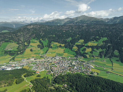 Aerial view of San Candido town as seen from Croda dei Baranci (Birkenkofel) mountain peak on the Dolomites range, Innichen, Trentino, South Tyrol, Italy.