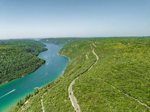 Aerial view of a road on the hills following the Limski Fjord (Canal di Leme) in Sveti Lovrec, Istria, Croatia.