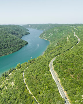 Aerial view of a road on the hills following the Limski Fjord (Canal di Leme) in Sveti Lovrec, Istria, Croatia.