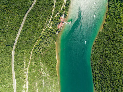 Aerial view of a road on the hills following the Limski Fjord (Canal di Leme) in Sveti Lovrec, Istria, Croatia.