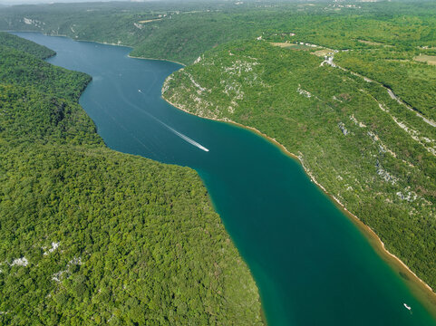 Aerial view of boats sailing along the Limski Fjord (Canal di Leme) in Sveti Lovrec, Istria, Croatia.